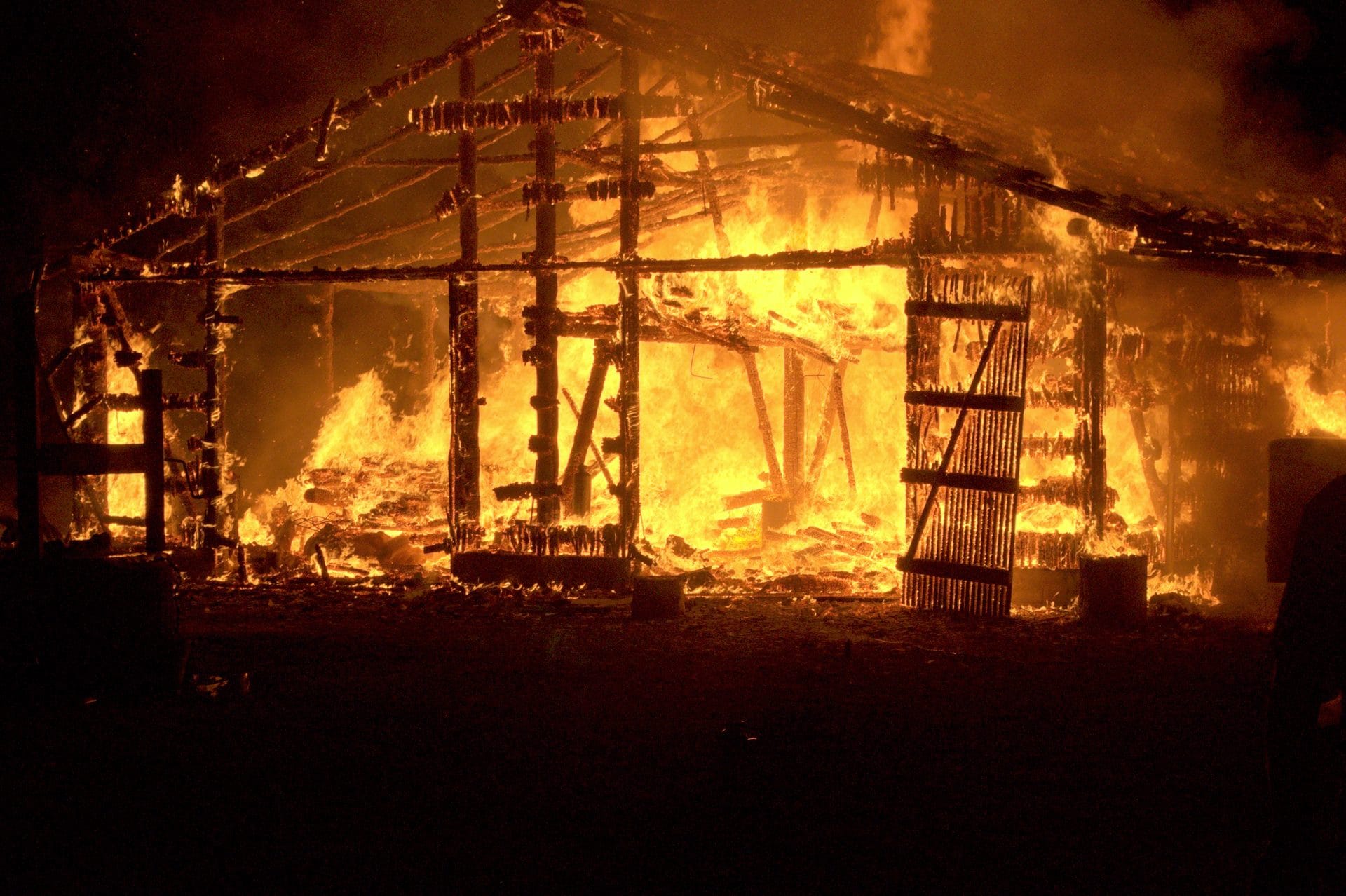 NIKON CORPORATION NIKON D5000 · 55 mm · f/9 · 1/320 s A burning structure at night with flames engulfing the wooden beams and walls.