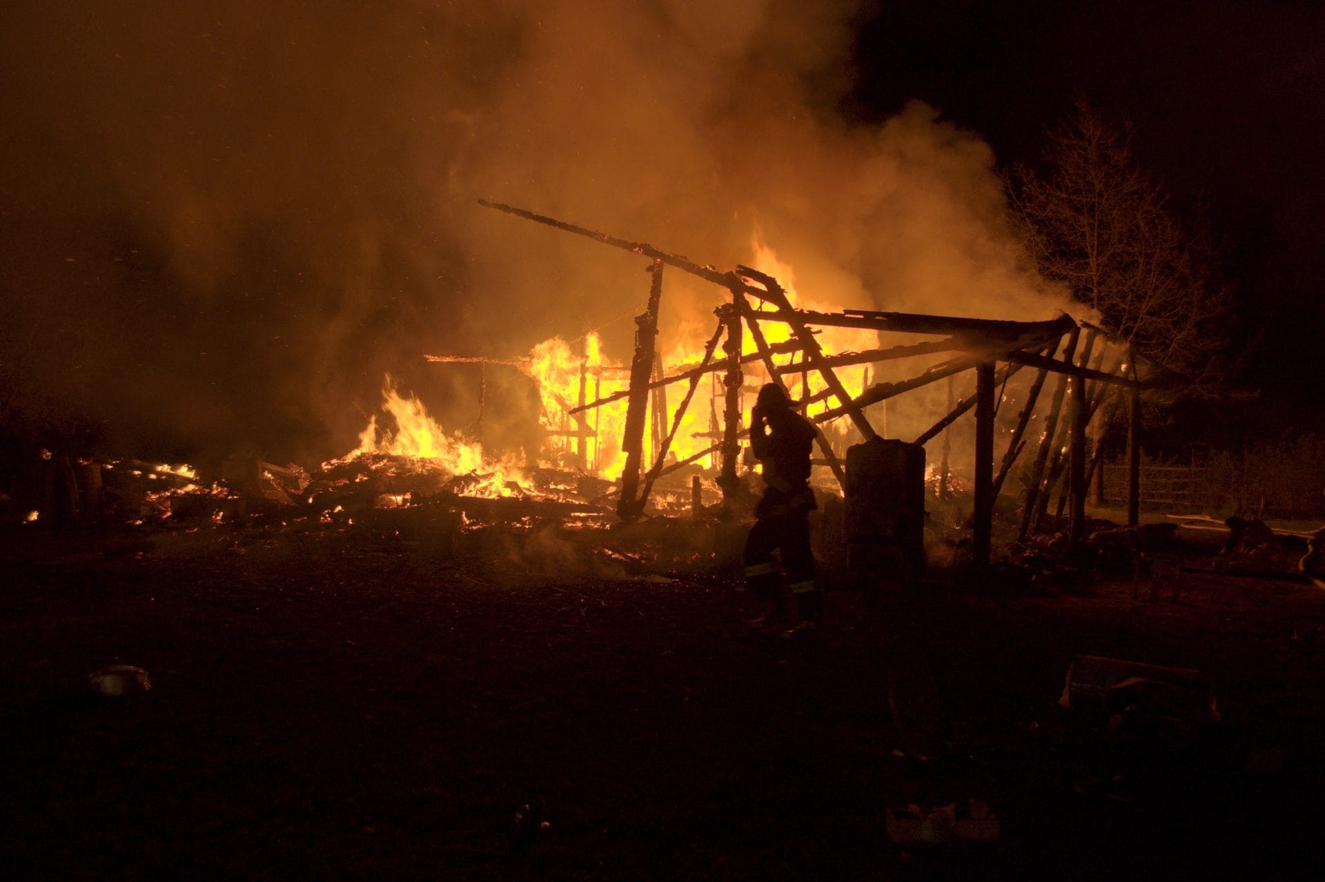 NIKON CORPORATION NIKON D5000 · 22 mm · f/4.5 · 1/80 s A nighttime scene of a large fire consuming a wooden structure and debris.