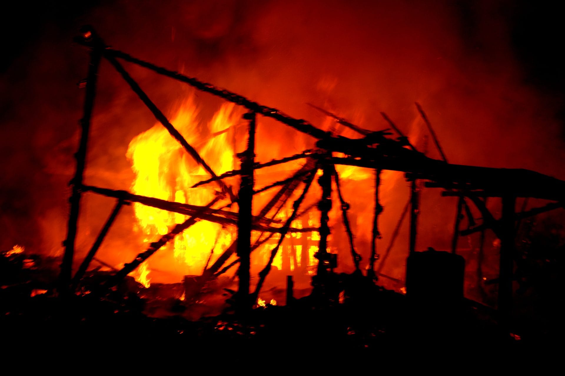 NIKON CORPORATION NIKON D5000 · 55 mm · f/5.6 · 1/30 s A nighttime scene of a large fire consuming a wooden structure.