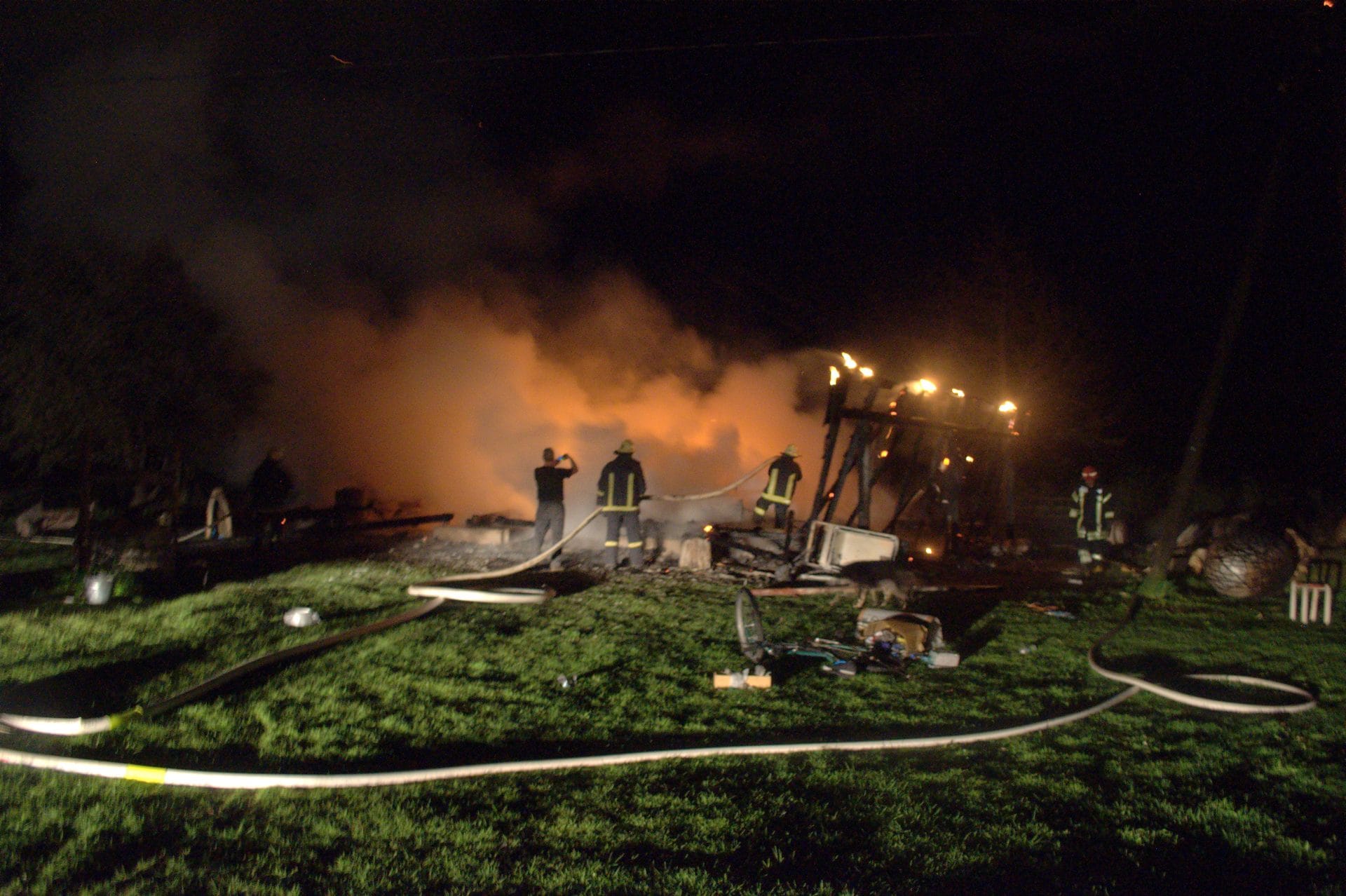 NIKON CORPORATION NIKON D5000 · 18 mm · f/3.5 · 1/2 s A nighttime emergency response scene with firefighters and emergency vehicles.